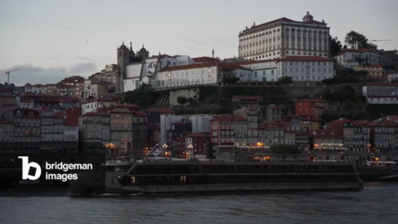 Image of Luxury river cruise boat passing Ribeira district from across the